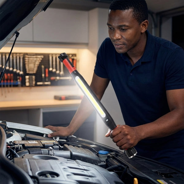 A person using a Rechargeable Magnetic LED Work Light Bar while working under the hood of a car.