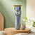 Rechargeable Hair Clipper Grooming Kit displayed on a wooden surface with decorative elements.