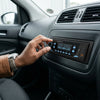 A person adjusting the Dual USB Car MP3 Player in a car dashboard for better audio experience.