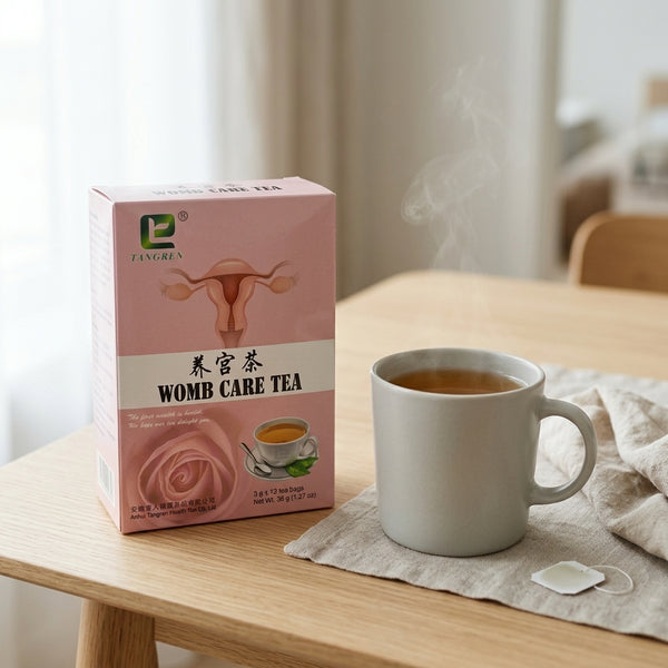 Womb Care Herbal Tea - Women’s Wellness & Herbal Infusion package next to a steaming cup of tea on a wooden table.