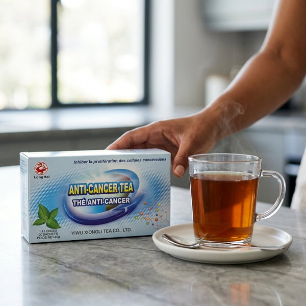 Anti-Cancer Tea packaging next to a cup of brewed tea on a kitchen counter.
