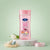 Vitamin B3 Vitamin E Body Oil Gel in a pink bottle on a marble surface with flowers and decorative eggs.