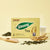 Herbal Tea Ginseng product box with ginseng roots and tea cup on a yellow background.