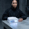 36W UV Nail Curing Lamp in use with a woman curing her gel nails under the lamp, showcasing its compact design and functionality.