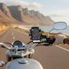 Motorcycle handlebar with Universal Bike & Motorcycle Phone Mount holding a smartphone displaying GPS navigation.
