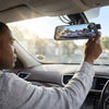 A driver adjusting the view of the 1080P Dual Lens Super Night Vision Dashcam mounted on their vehicle.