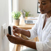 Woman installing the Mini Repeater 300Mbps Signal Amplifier in a home for better Wi-Fi coverage.