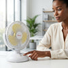 A woman operating an 8 Inch DC Circulation Fan at her desk in a bright office space.