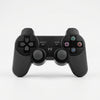 PS3 Wireless Controller + Charging Cable - Black wireless gamepad with buttons and joystick.