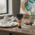 Acrylic Paint 75ml Orange-Red displayed on a table with paint palette and brushes in a bright art studio.