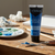 Acrylic Paint 75ml - Phthalocyanine Blue tube beside a palette and painting tools on a wooden table.