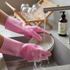 Heat Resistant Silicone Scrubber Magic Gloves in action, washing a bowl at the sink with running water.