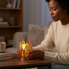 Gold Leaf Tealight Candle Holder in use, creating a warm ambiance on a table by a cozy couch.