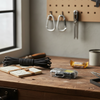 Mini Keychain LED Flashlight & Lighter on a wooden table with tools and accessories.