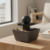 Indoor Tabletop Water Fountain Decor with flowing water and decorative stones on a wooden table.