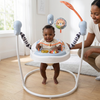 Baby Learning Jumper Activity Center with a baby playing and smiling while an adult watches.