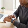 Rugged Silicone Sport Band for Apple Watch Ultra worn by a person checking the time while working.