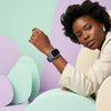 Rugged Silicone Sport Band for Apple Watch Ultra displayed on a model's wrist with colorful geometric background.