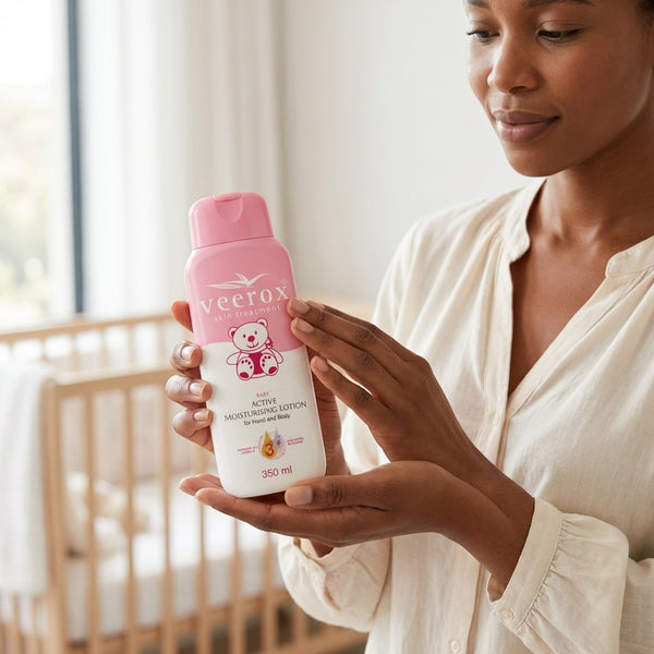 A parent holding Vitamin E Enriched Baby Body Cream in a cozy nursery setting.
