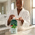 Herbal Camphor Active Moisturising Body Lotion in use by a woman applying lotion in a luxurious bathroom.
