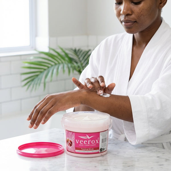 Woman applying Tropical Musk Skin Treatment 1L moisturizer from a tub for hydrated skin.