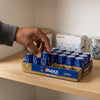 Person picking D Cell Batteries 24 Pack from a shelf, showcasing reliable power for everyday devices.