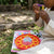Child using Soap Bubble Maker 170ml to blow bubbles outdoors, surrounded by grass and playing joyfully.