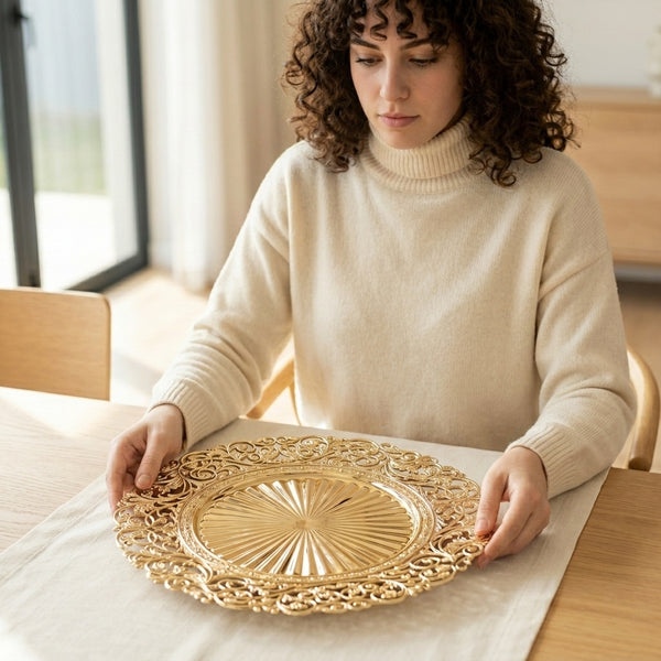 A woman holding a decorative 13-inch Eco-Friendly Charger Plate while setting the table.