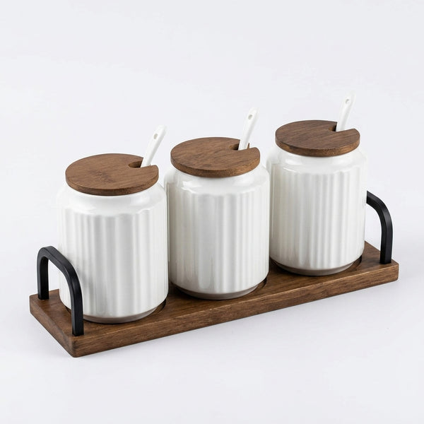 Ceramic Seasoning Jar Set with Wooden Tray displaying three jars on a wooden tray with lids and spoons.