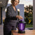Woman adjusting an Electric Mosquito Zapper LED Lamp to reduce insects during outdoor relaxation.