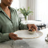 European Vintage Dinner Plate held by a person, showcasing elegant ceramic decor with a detailed edge.