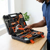 Multi-Function Household Combination Set: Person holding a hammer next to an open tool kit featuring various tools and a plant in the background.