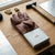 Reinforced Leather Safety Gloves placed on a wooden table next to tools and equipment for protection in manual work.