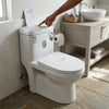 Modern Ceramic One-Piece Toilet Unit installed in a stylish bathroom with a person adjusting the flush.