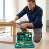A man using the 37 Piece Multifunctional Power Tool Set to work on a piece of furniture.