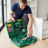Man examining tools in a 20-Piece Household Hand Tool Starter Kit while assembling furniture.