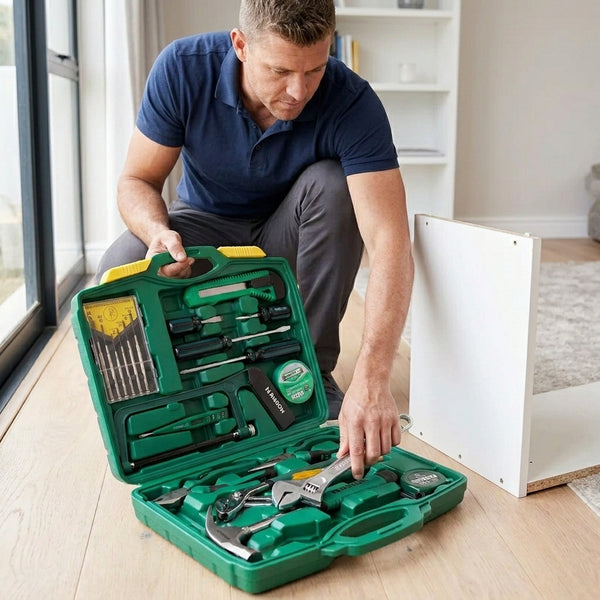 Man examining tools in a 20-Piece Household Hand Tool Starter Kit while assembling furniture.