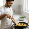 Natural Beechwood Cooking Spoon being used to stir colorful vegetables in a skillet.