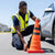 Person placing a Collapsible Reflective Traffic Safety Cone on the road for safety during an emergency.