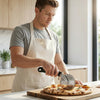 Man using Eco-Friendly Kitchen Pizza Cutter on freshly baked pizza in a modern kitchen.
