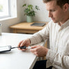 Man using a Micro USB to USB OTG Converter Adapter to connect a smartphone to a USB device.