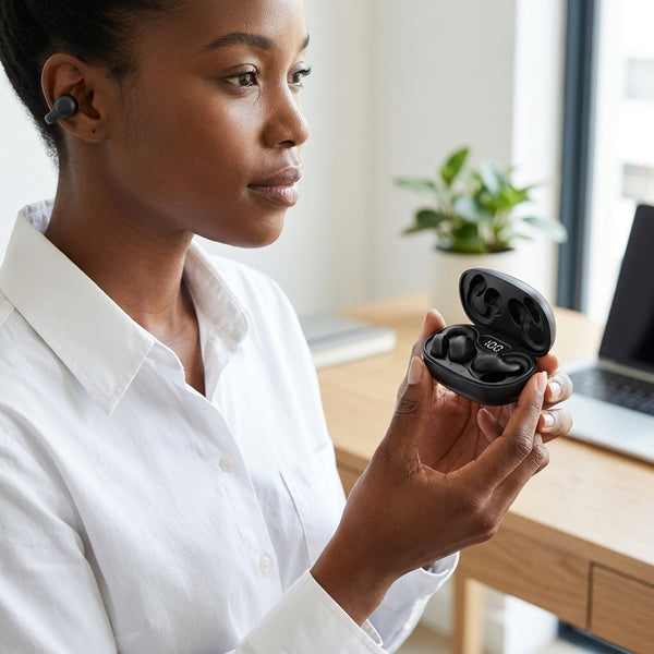 X58 TWS Wireless Ear Clip Sports Headphones held by a woman in a modern workspace, showcasing sleek design and earbuds.