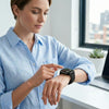 Woman using Z33 Model 8 Bluetooth Smartwatch to check notifications and track fitness in a modern workspace.