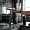Flexible Pull Down Deck Mounted Kitchen Faucet being used in a modern kitchen setting.
