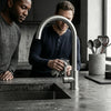 Classic Single Hole Kitchen Faucet with 360 Swivel showcased in modern kitchen with two men.