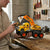 Child using the Remote Control Construction Engineering Excavator Truck on a workbench with tools in the background.