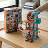 Childrens Modular City Parking Building Playset with cars and track design displayed on a coffee table.