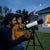 Father and child using the Children's High Definition Astronomical Telescope to observe the night sky.