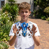 Boy holding a Rotating Aircraft Friction Inertia Stunt Car outdoors surrounded by greenery.