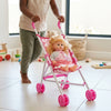 Child pushing a 12-Inch Baby Doll and Foldable Stroller with a baby doll inside, promoting imaginative play.